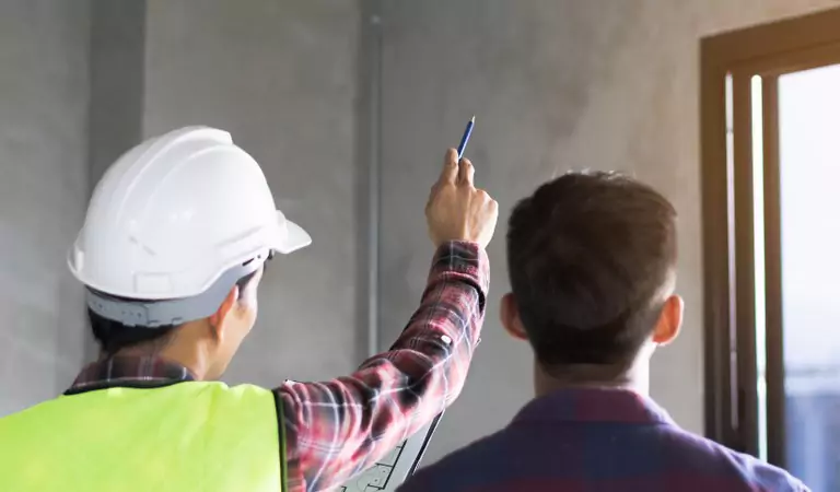 A professional and a person inspecting a property