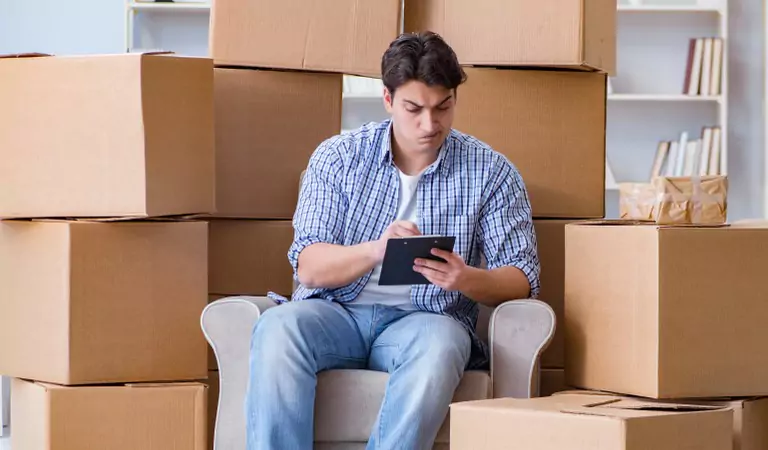 Man looking worried while searching for something on a tablet