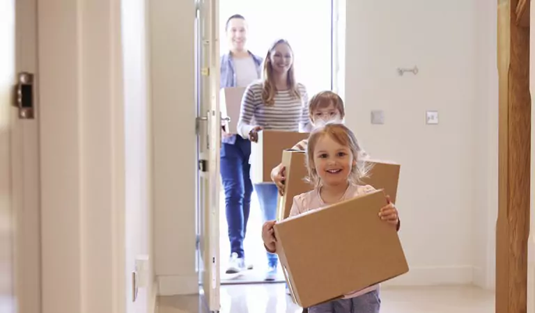 entire family heading inside of their new house