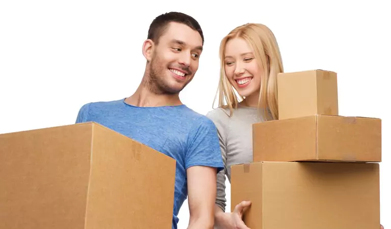 happy couple with cardboard boxes posing for a picture