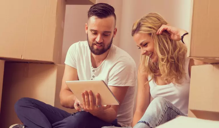 couple discussing something and searching for something on a tablet