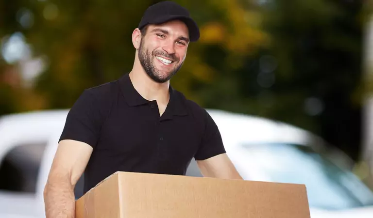 young man lifing a heavy cardboard box