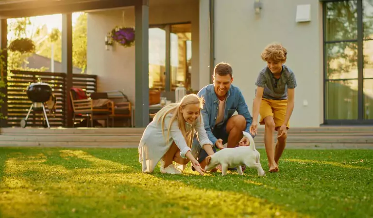 family with their pet enjoying in a lawn