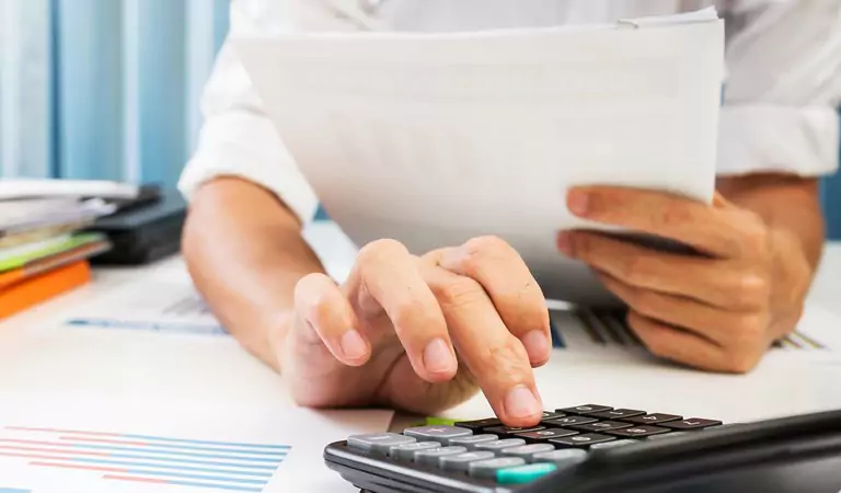 cropped picture of a person calculating the bills