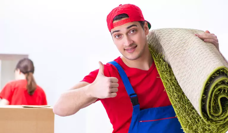 young professional with a mat on his shoulder showing thumbs up