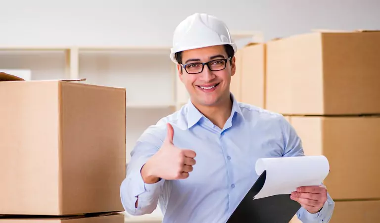 young man wearing a helmet showing thumbs up