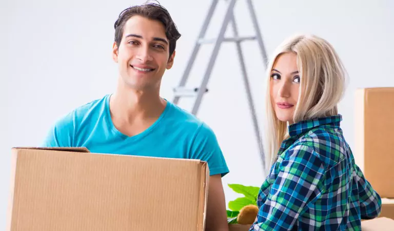 young man and a woman inside of their new house