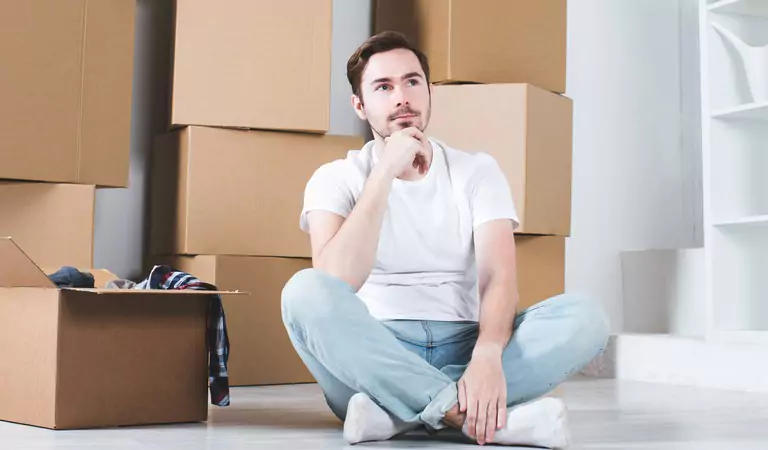 young man looking stressed and sitting on the floor