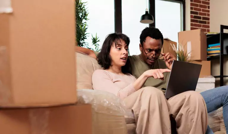 couple sitting on a couch and calculating something