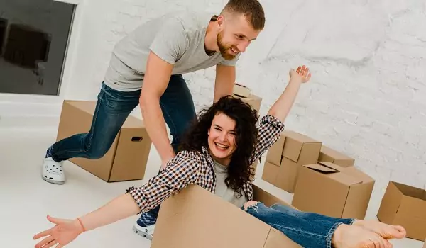 couple looking happy while moving house